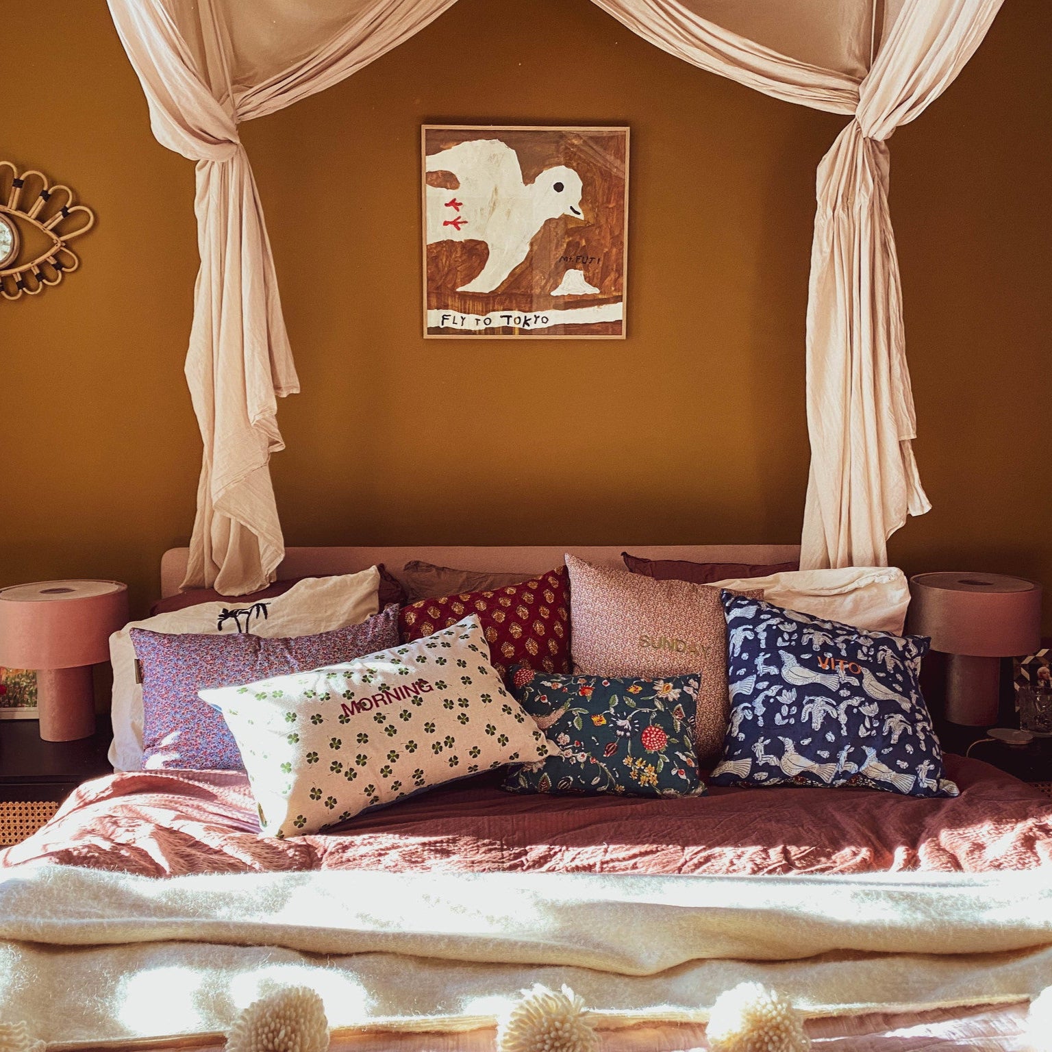 opgemaakt bed met gepersonaliseerde kussens.