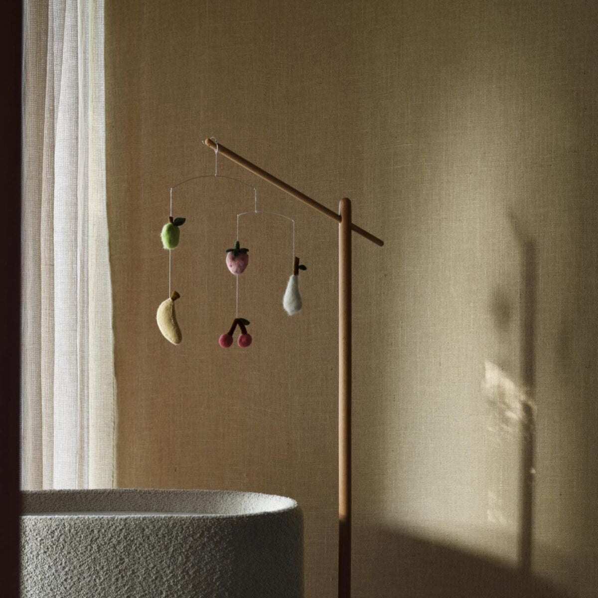 Mobiel met fruit hangend aan standaard